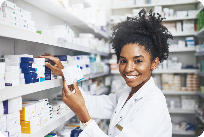 Pharmacist stocking medicine shelves