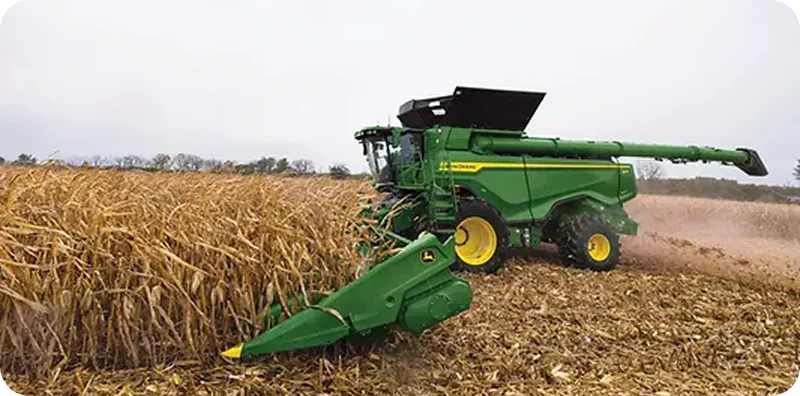 Combine harvester working a maize field